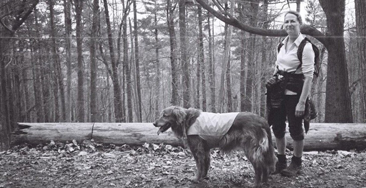 Mary Oliphant in woods with dog
