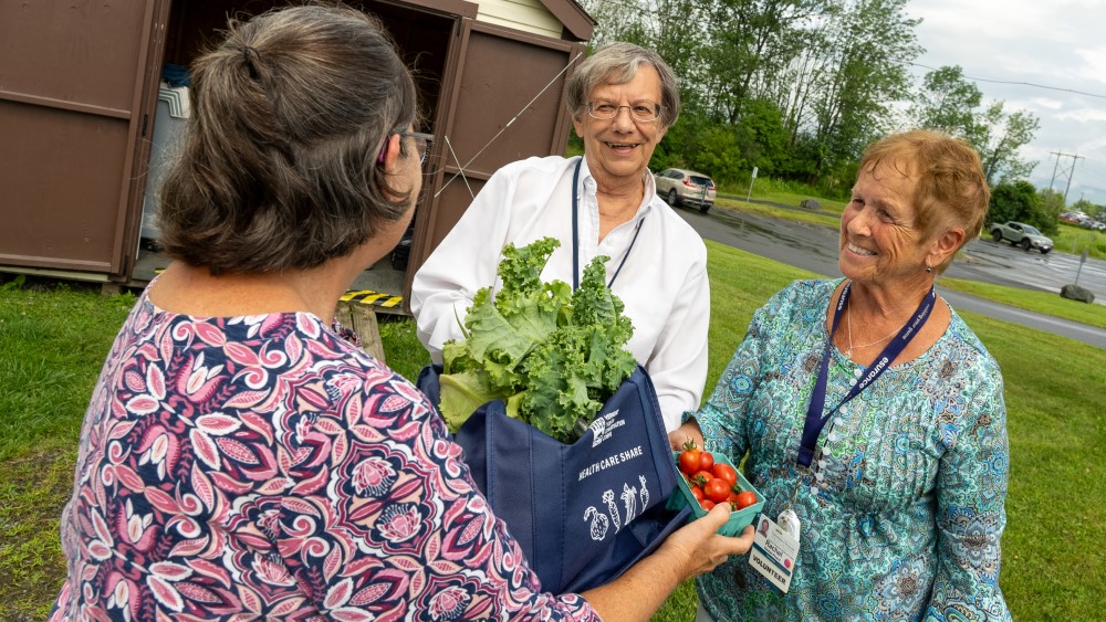 Patient picking up VYCC food share from staff