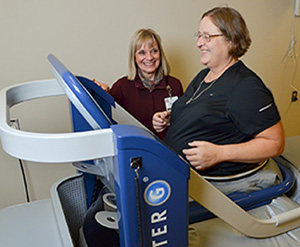 Susan Stephen, PT works with Candace Brown on the AlterG