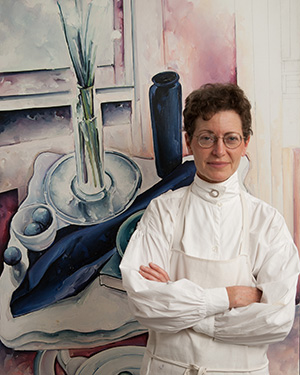 Margaret Sparrow standing in front of one of her paintings