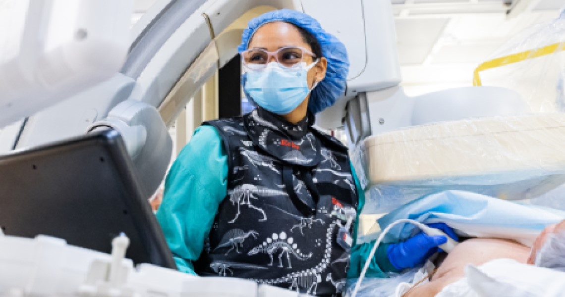 Female technician performing TAVR procedure.