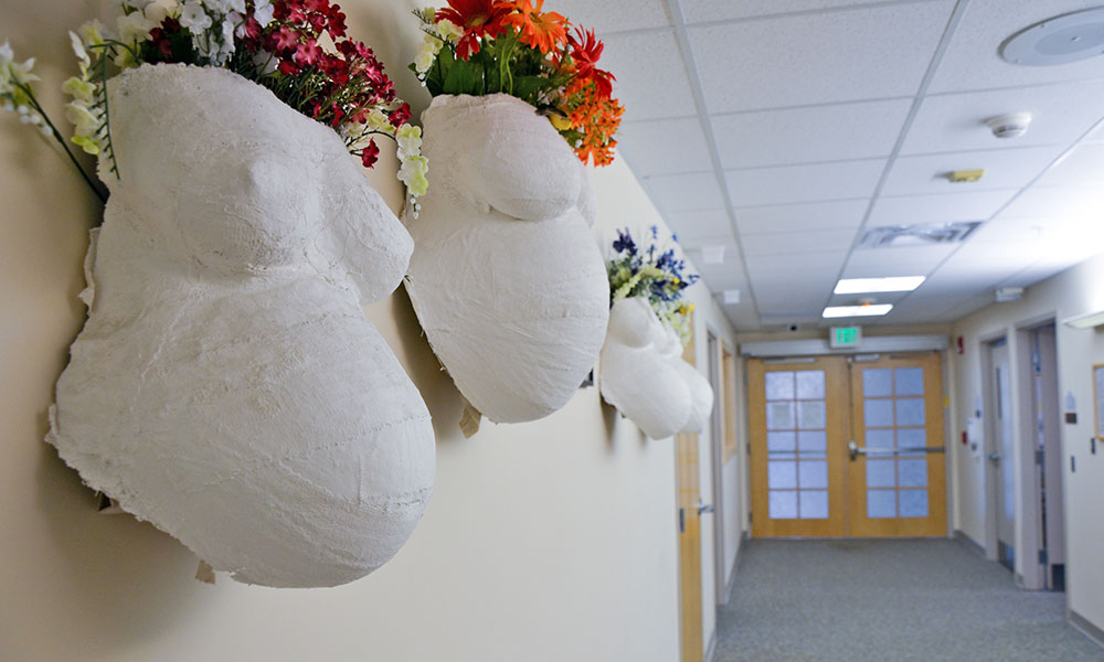 Decorated belly casts hanging on wall of CVMC Birthing Center